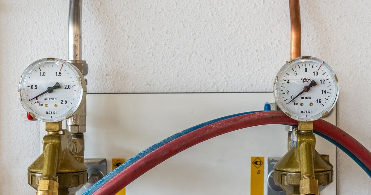 Close-up of pressure-washer control gauges and hoses — equipment-driven insurance risk for pressure washing operators